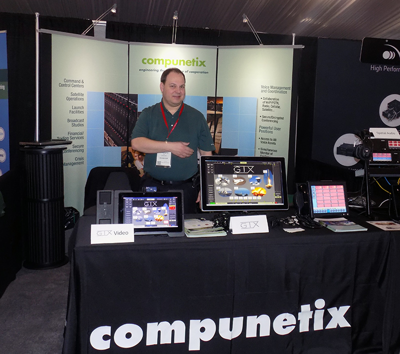 Chris Fry (Program Manager with Federal Systems Division) at the Compunetix booth at a previous Space Symposium show